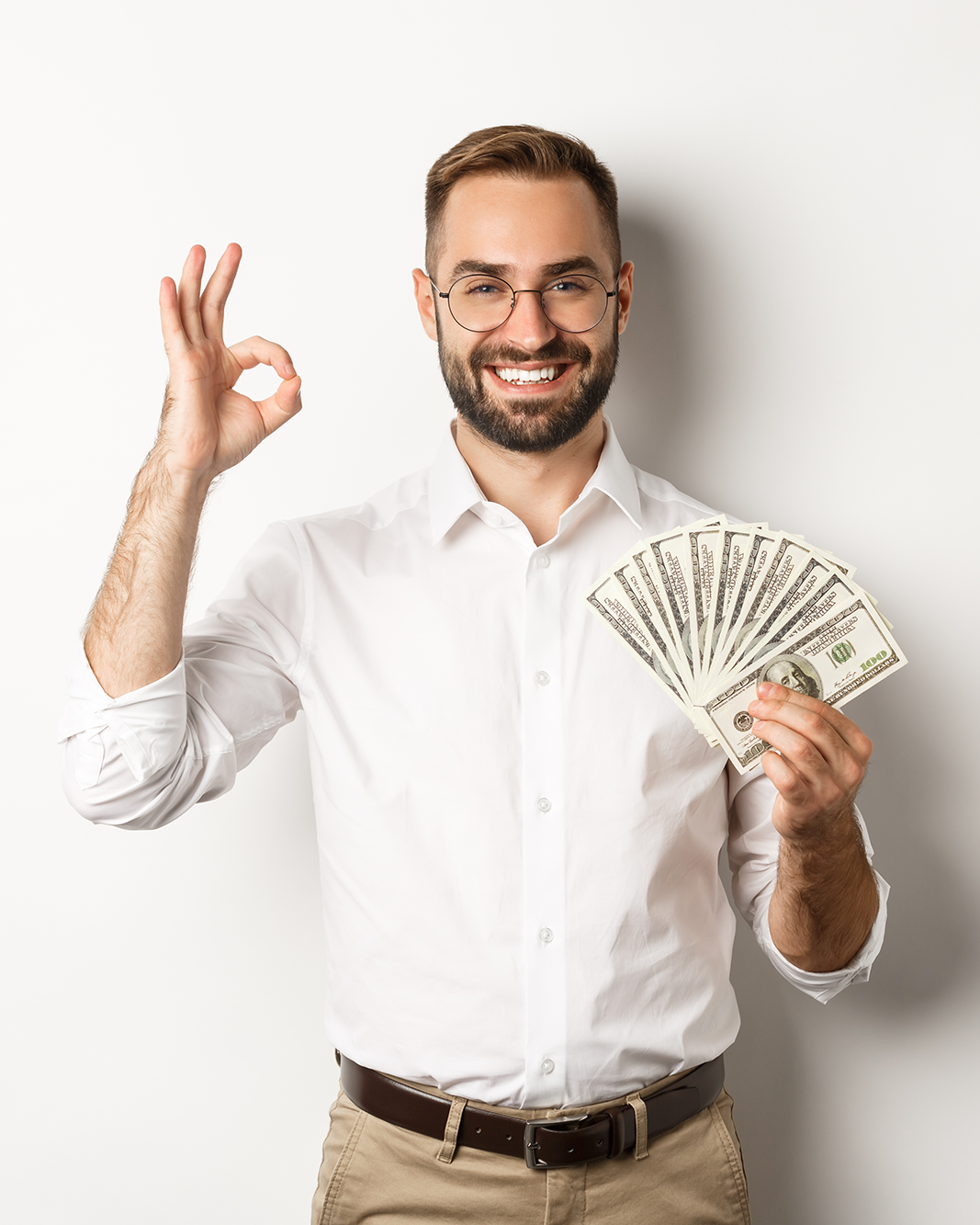 satisfied-young-businessman-showing-money-make-okay-sign-earning-cash-standing-white-background-(1)